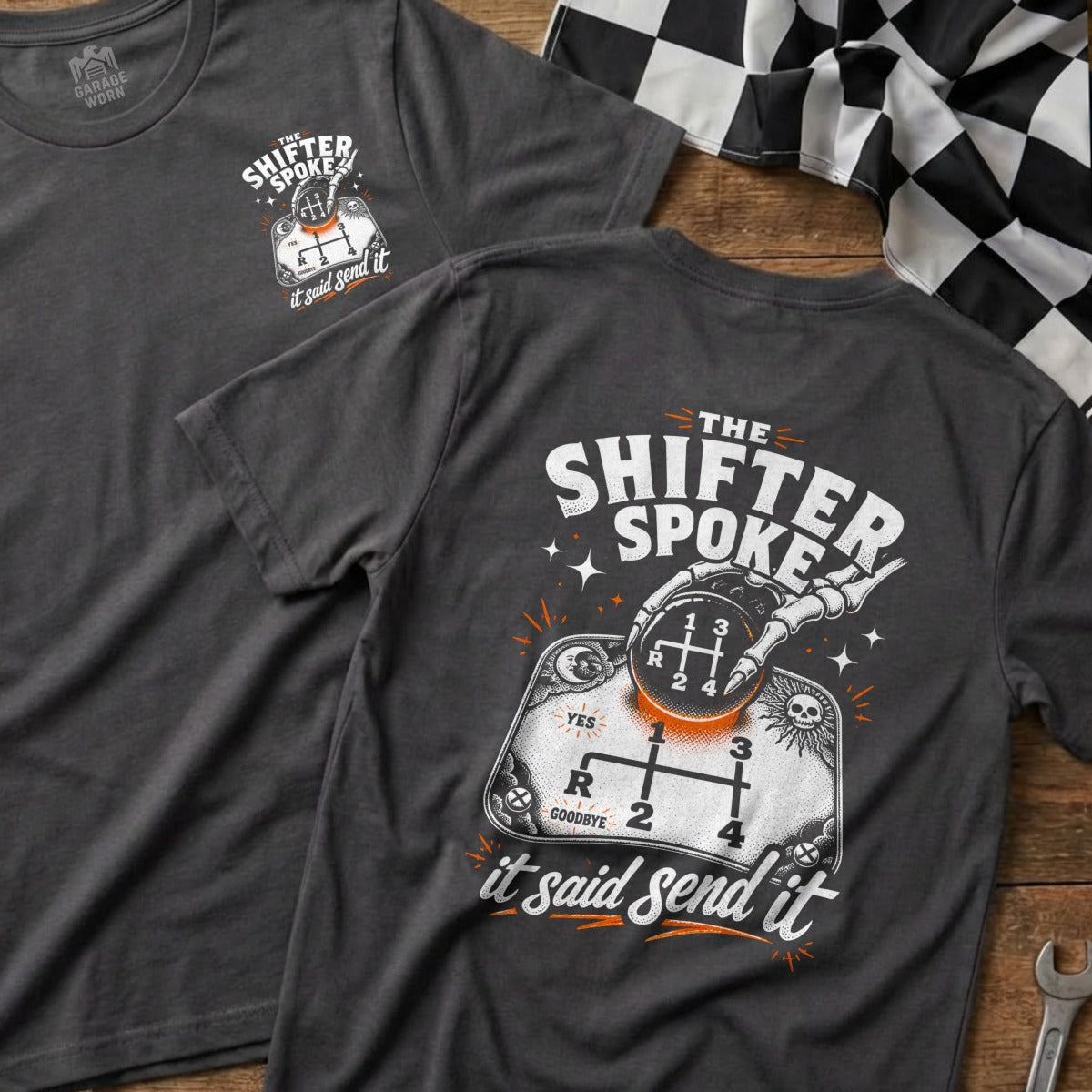 Dark gray t-shirt with a skeleton hand holding a gear shift knob and "The Shifter Spoke it said send it" text.