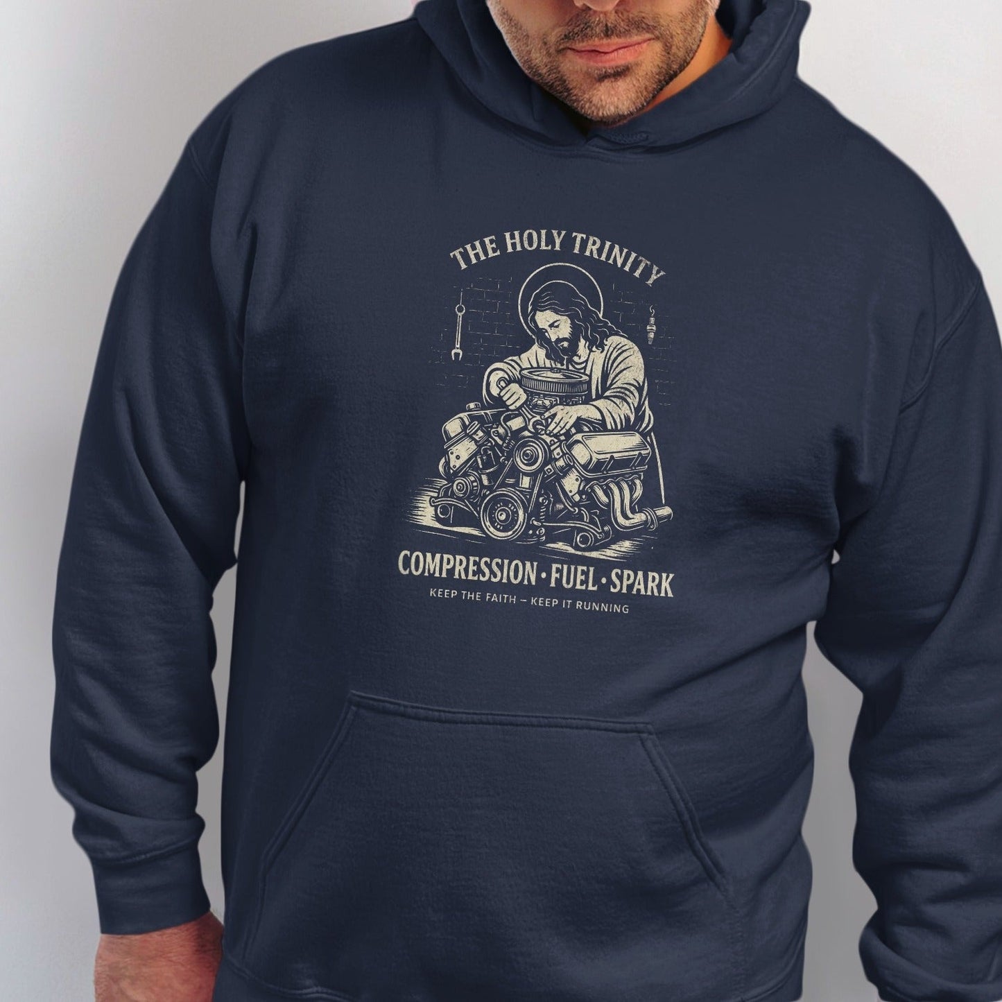 Jesus working on an engine with text "The Holy Trinity Compression Fuel Spark".