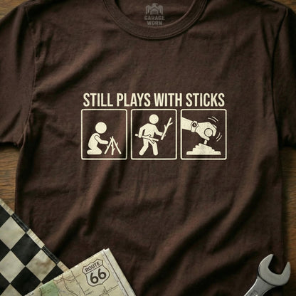 T-shirt with three icons: person with sticks, person building, person using a tool.
