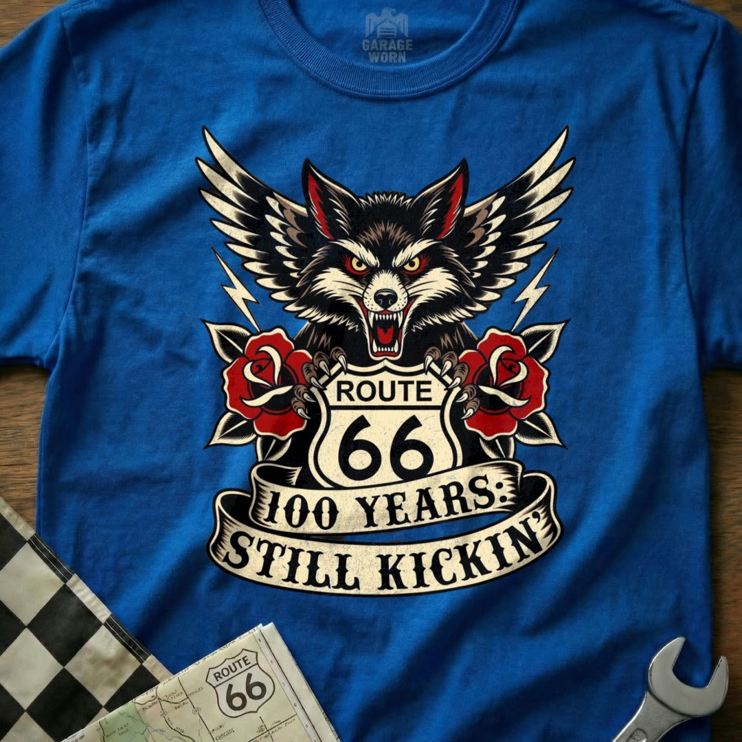 Route 66 100 Years Still Kickin' wolf graphic on a blue t-shirt.
