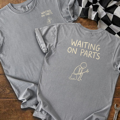 Gray t-shirts with "Waiting On Parts" text and a stick figure holding a bolt.