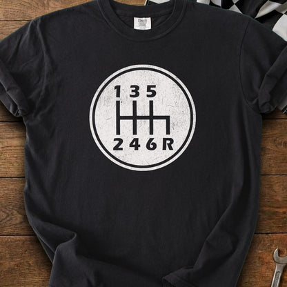 Black t-shirt with a white graphic of a 6-speed manual transmission shift pattern.
