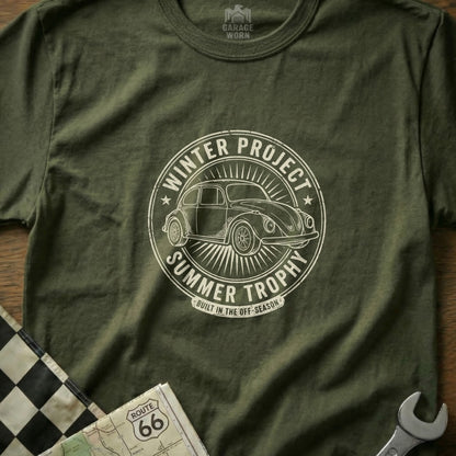 Green t-shirt with circular "Winter Project Summer Trophy" graphic featuring a Volkswagen Beetle.