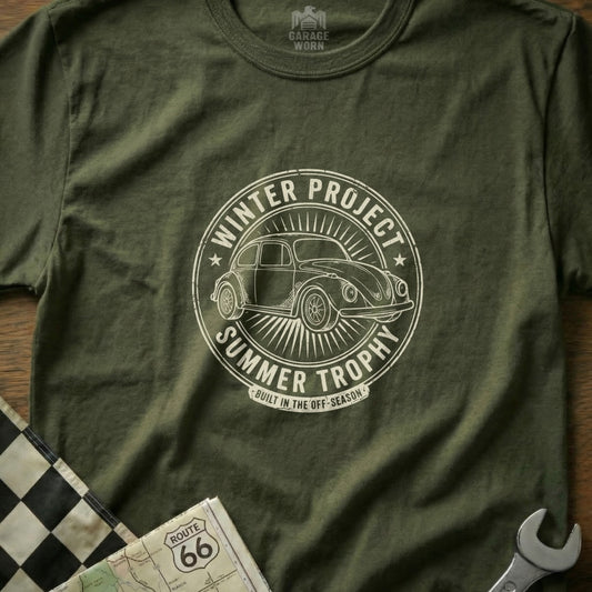 Green t-shirt with circular "Winter Project Summer Trophy" graphic featuring a Volkswagen Beetle.