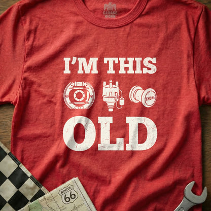 Red t-shirt with "I'M THIS OLD" and car parts graphic.