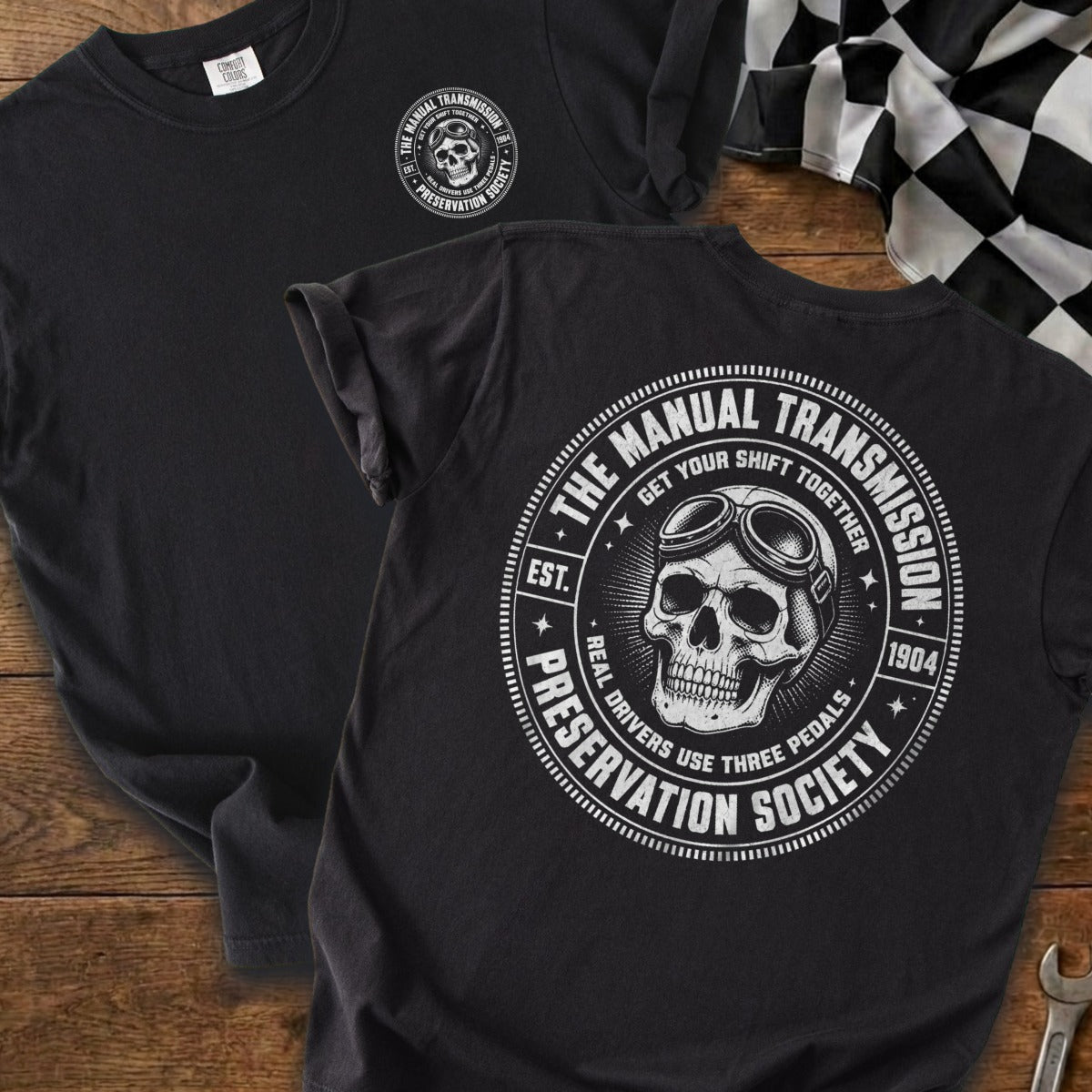 Black t-shirt with white skull wearing goggles and circle design about manual transmissions.