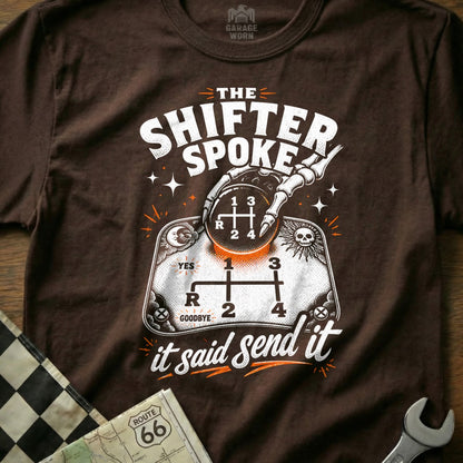 Brown t-shirt with "The Shifter Spoke" and skeleton hand on gear shift.