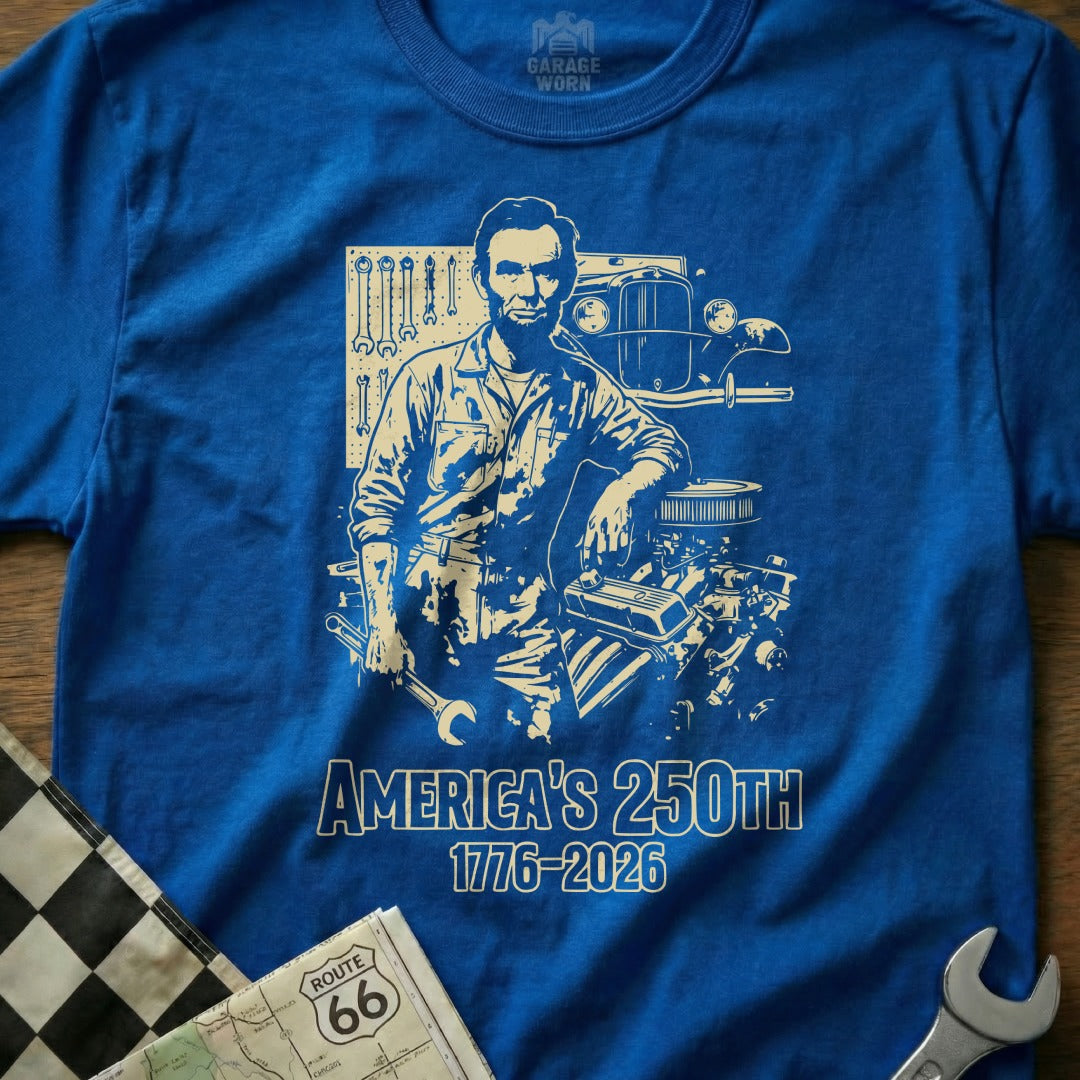 Blue t-shirt with Abraham Lincoln and an engine, celebrating America's 250th anniversary.