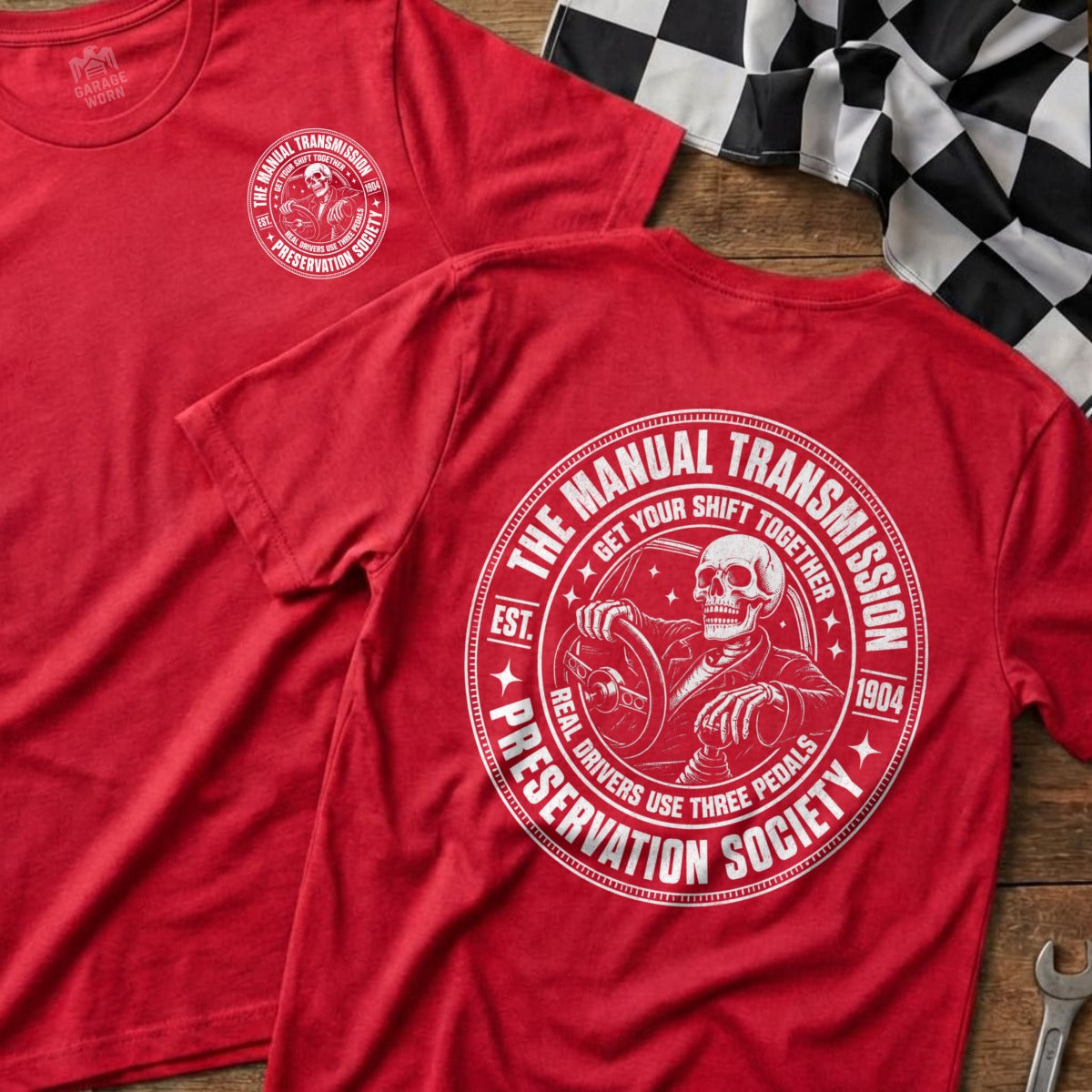 Red t-shirt with "The Manual Transmission Preservation Society" graphic featuring a skeleton driving.