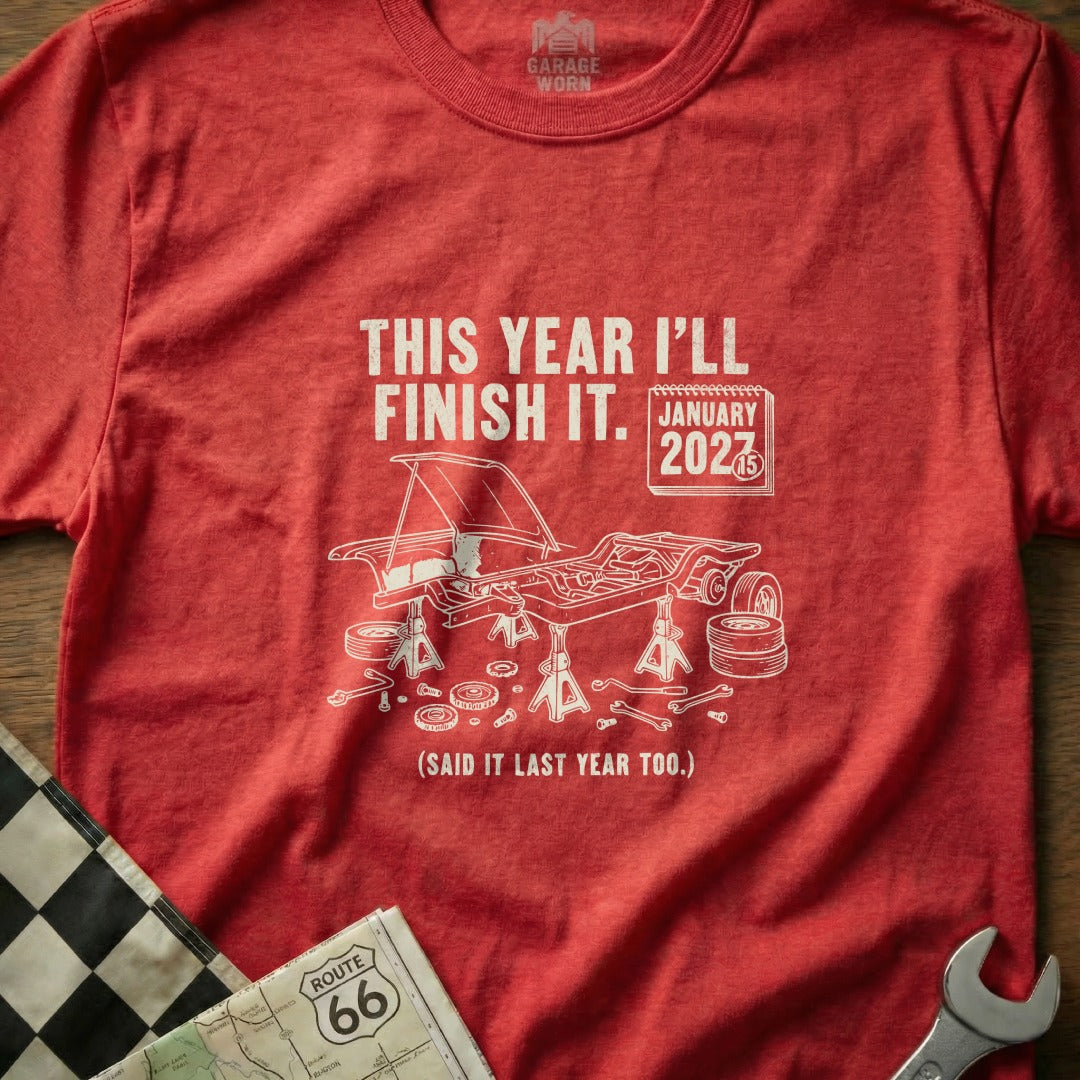 Red t-shirt with "This Year I'll Finish It." and car chassis graphic.
