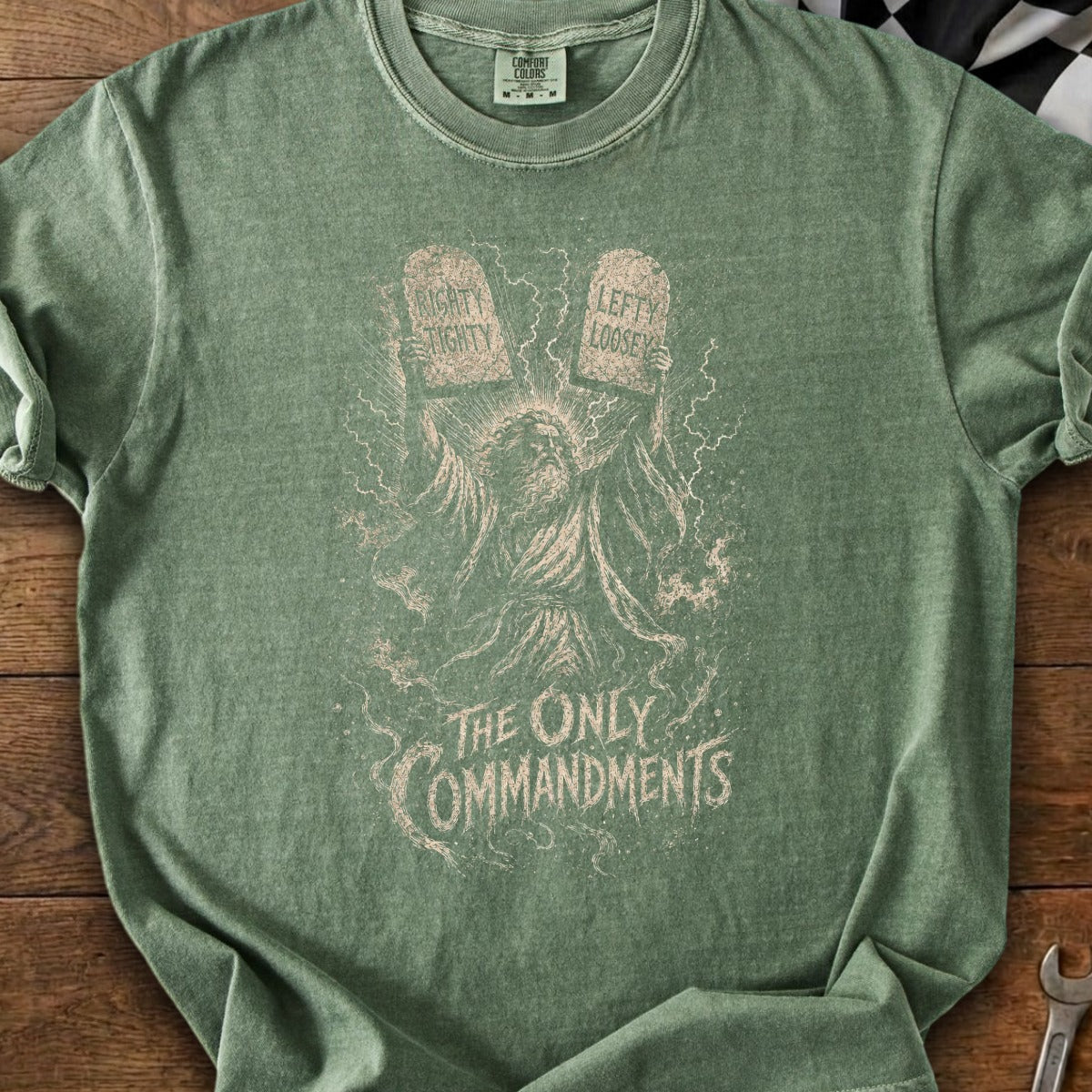 Green t-shirt with illustration of Moses holding tablets labeled "Righty Tighty" and "Lefty Loosey."