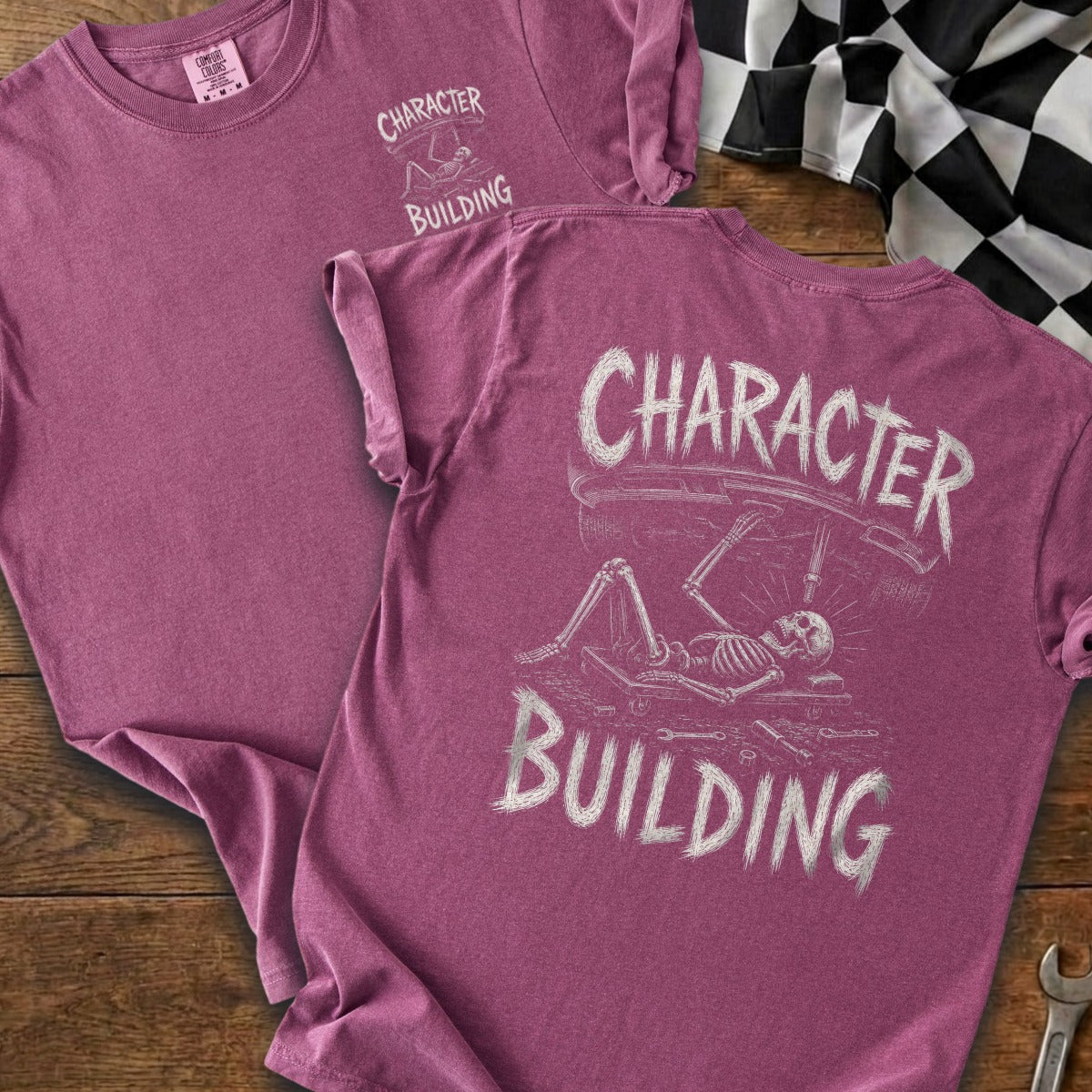 T-shirts with "CHARACTER BUILDING" and skeleton working on a car graphic.