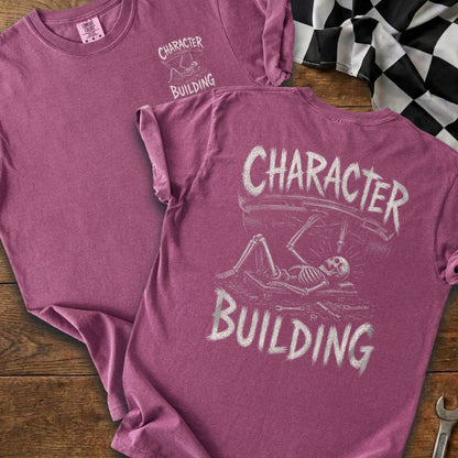 T-shirts with "CHARACTER BUILDING" and skeleton working on a car graphic.