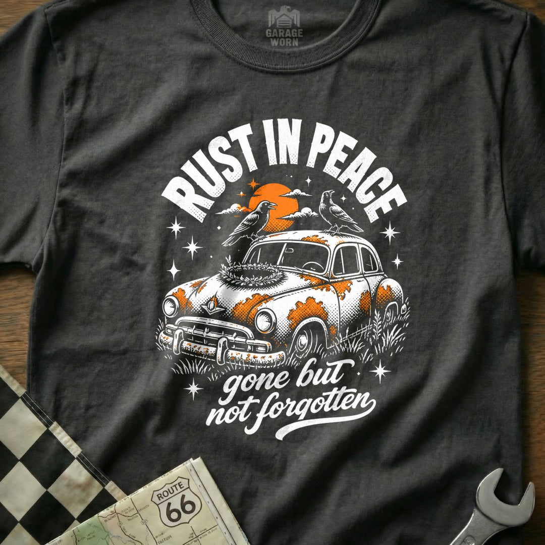 T-shirt graphic: rusted car with birds, sun, and text "RUST IN PEACE" and "gone but not forgotten".