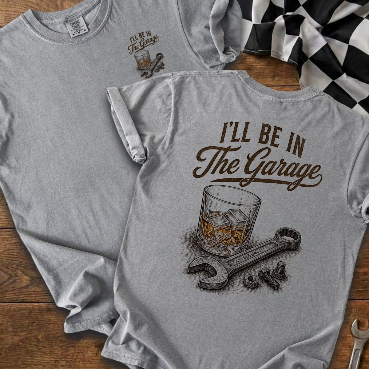 Gray t-shirt with "I'll Be In The Garage" text, whiskey glass, and tools.