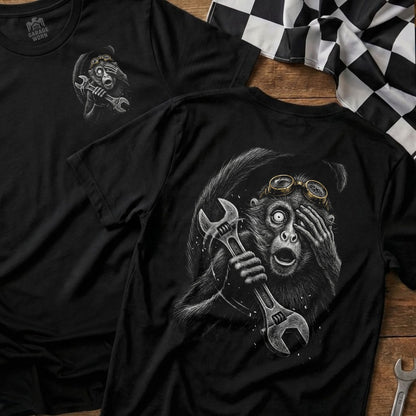 Black t-shirt with graphic of a startled monkey holding a wrench.
