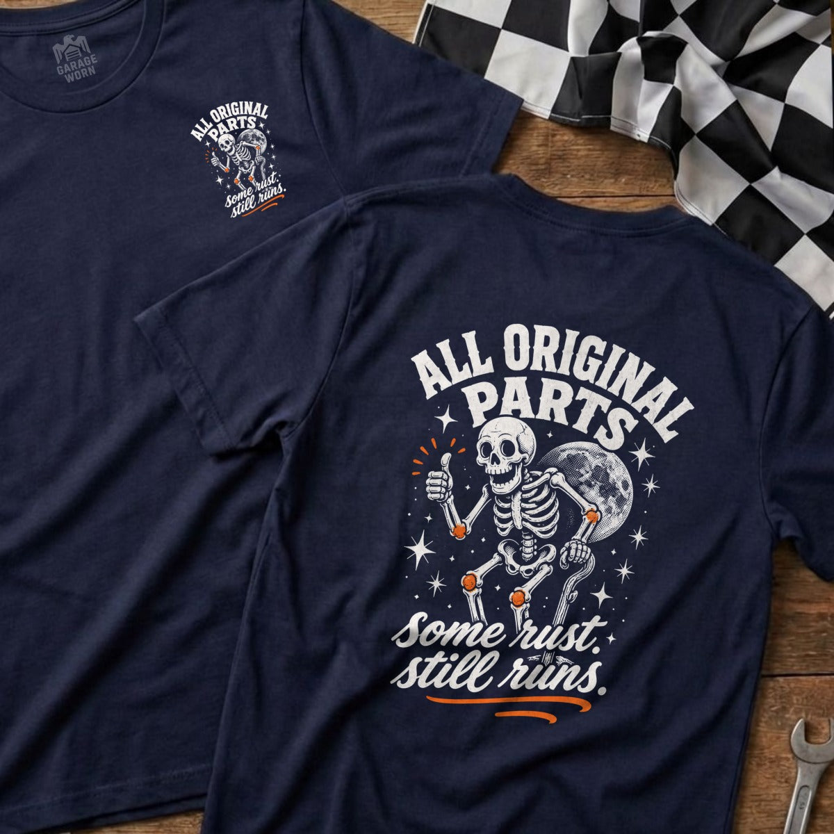 Navy t-shirt with skeleton giving a thumbs up, moon, and text "All Original Parts. Some Rust. Still Runs."