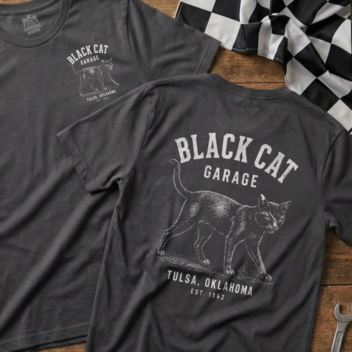 Dark grey t-shirts with a black cat graphic and "Black Cat Garage Tulsa, Oklahoma Est. 1962" text.