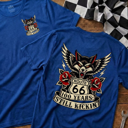 Blue t-shirt featuring a wolf, Route 66 logo, and "100 YEARS: STILL KICKIN'".