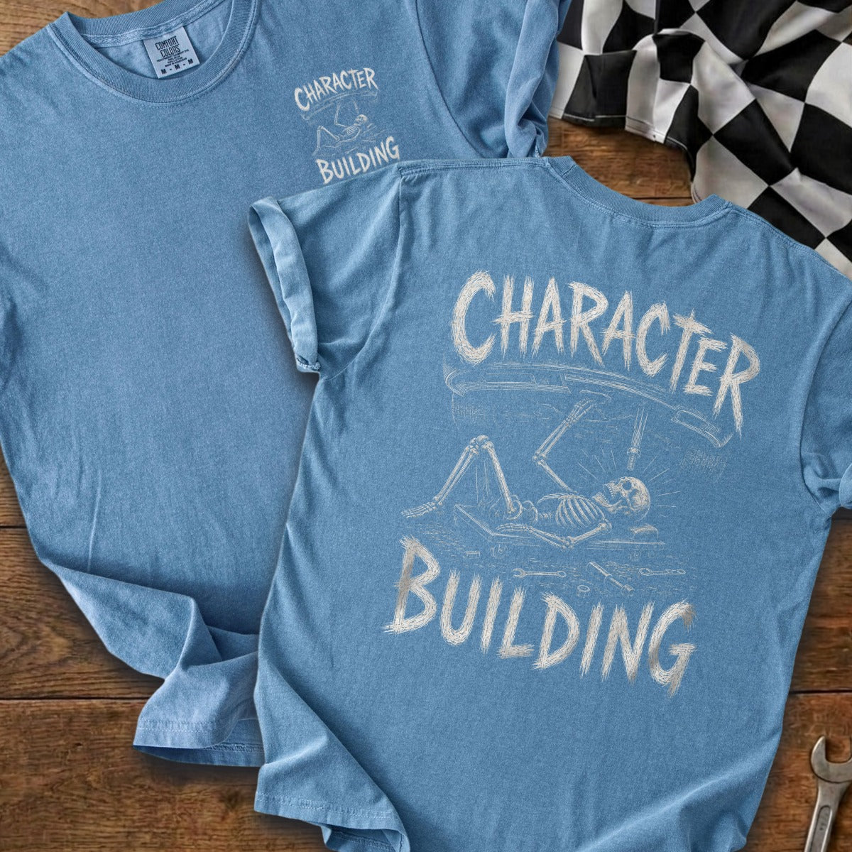 Blue t-shirt with skeleton graphic and text "CHARACTER BUILDING"