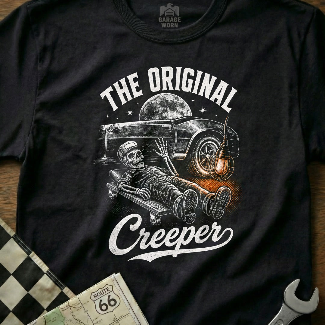 Skeleton on creeper under classic car with text "The Original Creeper"