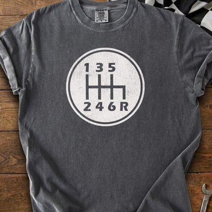 Charcoal shirt with white graphic of a manual transmission shift pattern.