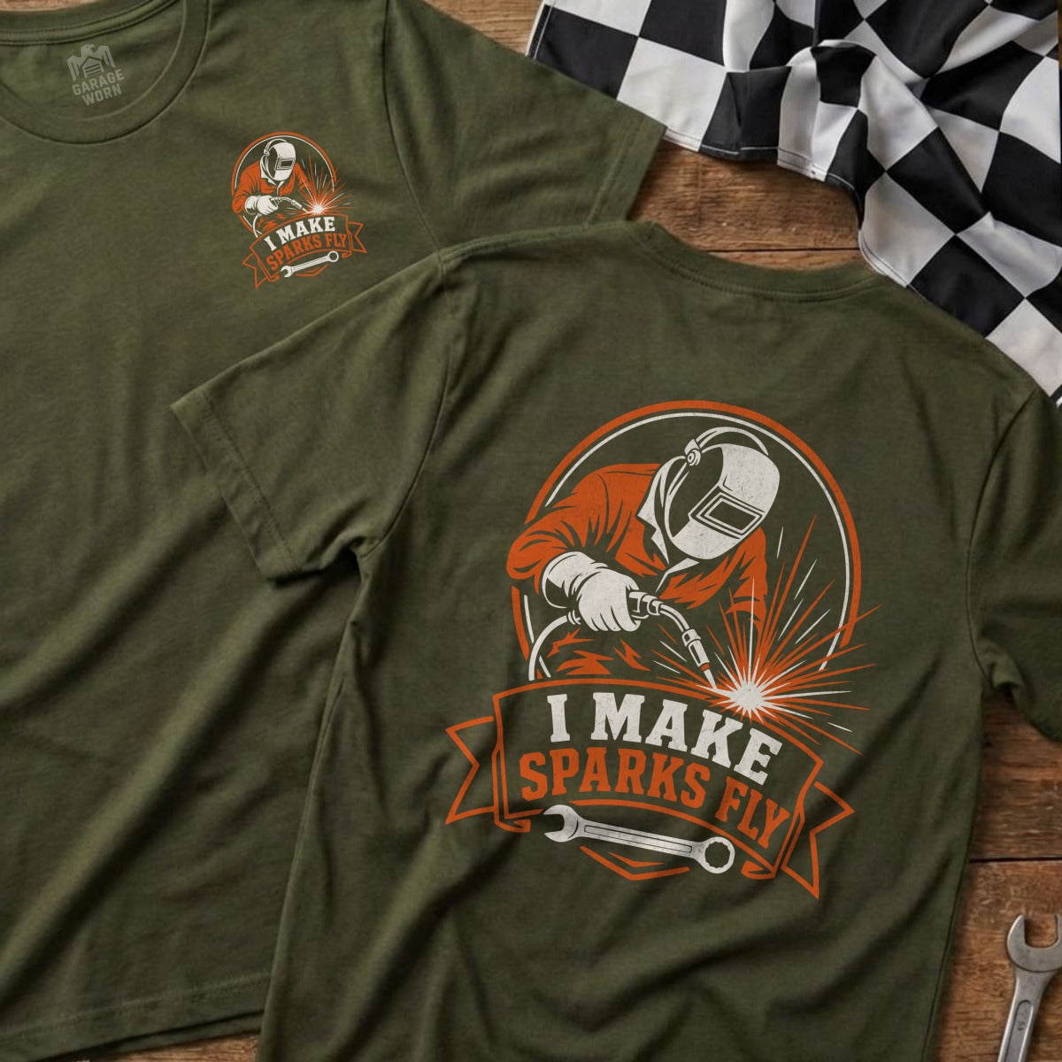 Green t-shirt with graphic of welder and text "I MAKE SPARKS FLY".