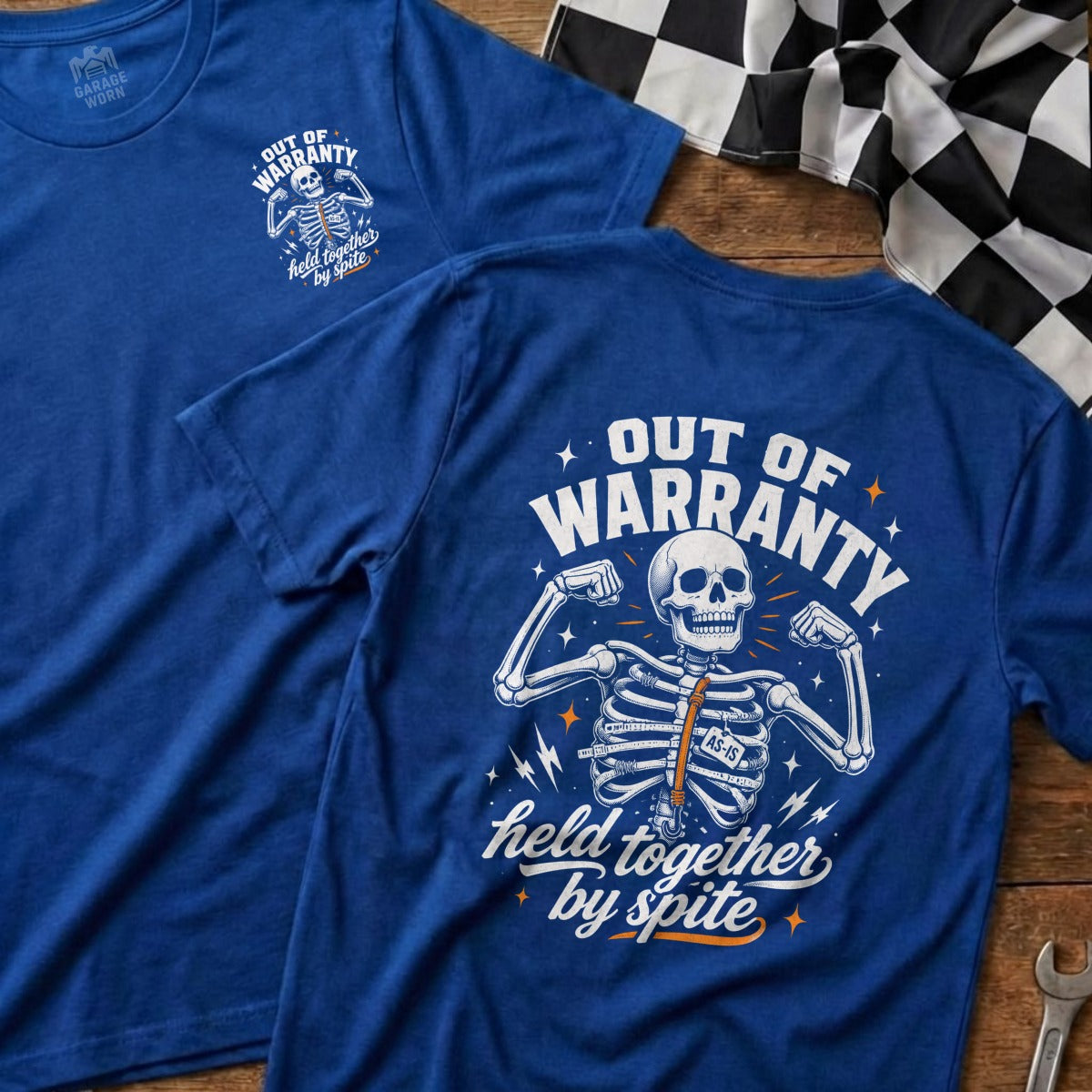 Blue t-shirt with skeleton graphic that says "Out of Warranty, Held Together by Spite."