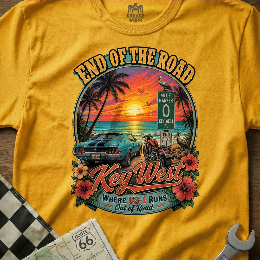 Yellow t-shirt graphic with "End of the Road Key West" text, vintage car, motorcycle, and beach scene.