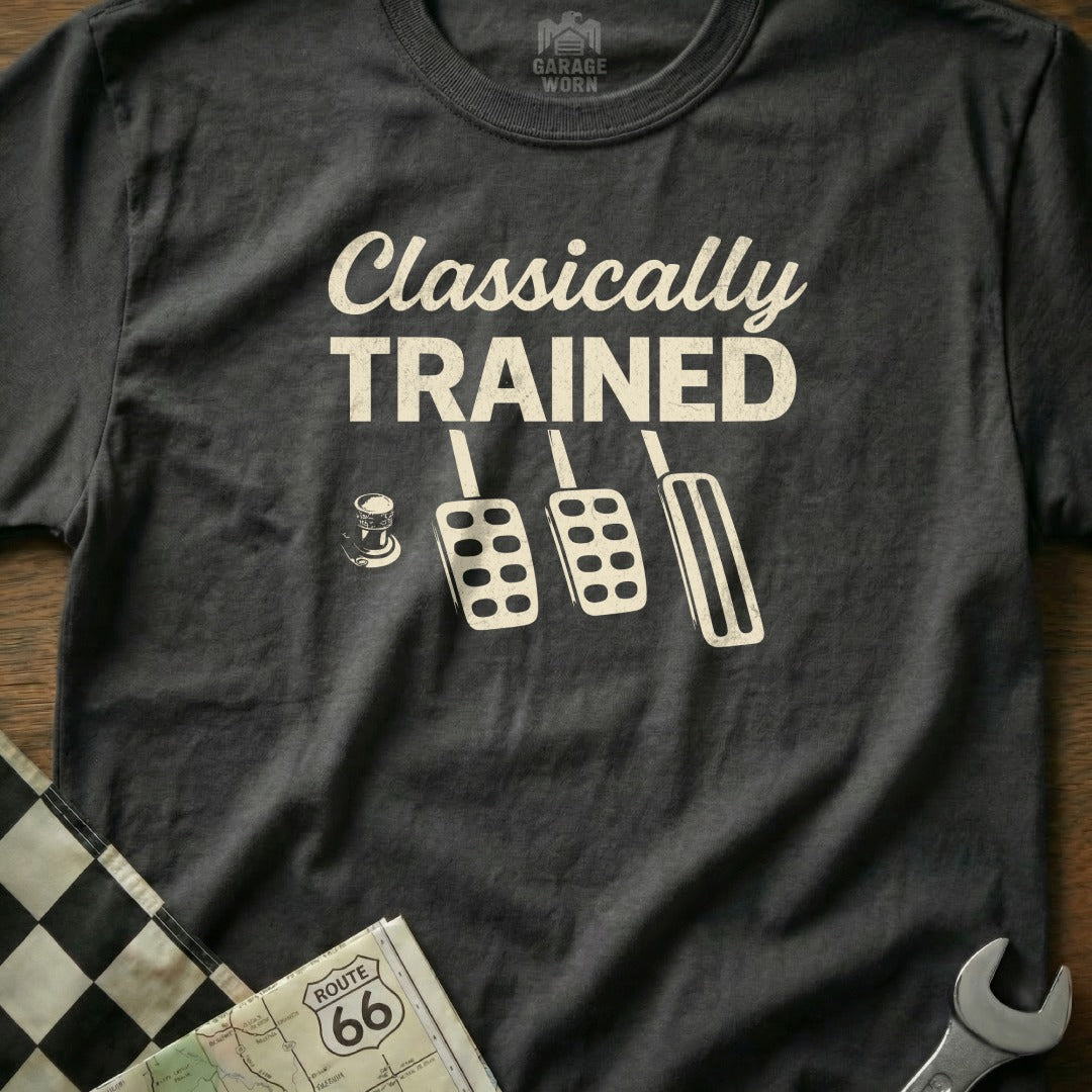 Black t-shirt with "CLASSICALLY TRAINED" and car pedals.