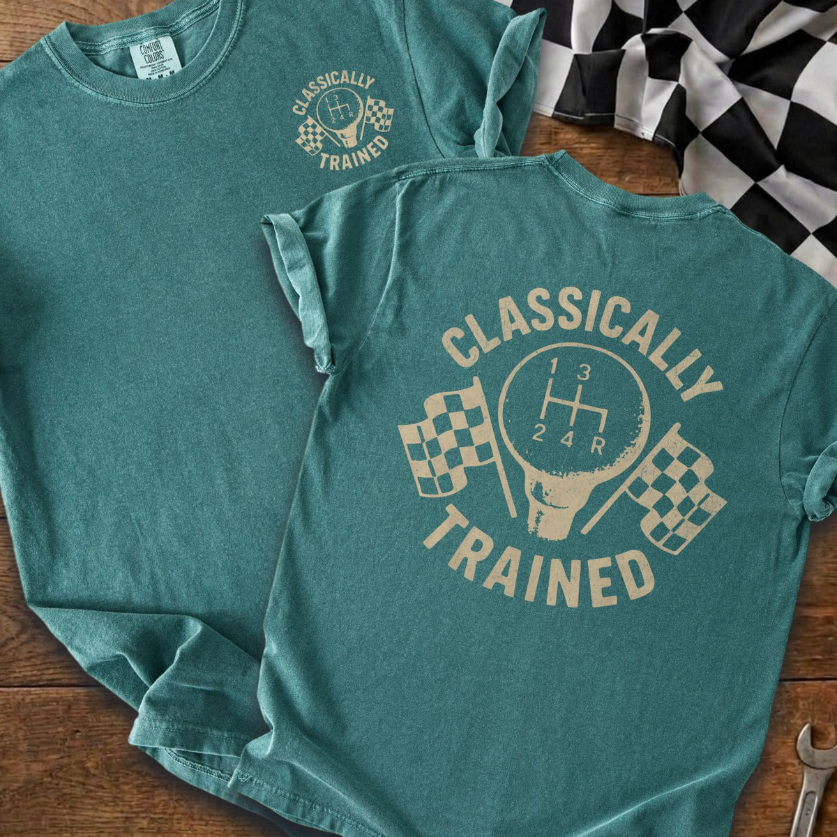 Teal t-shirt with "CLASSICALLY TRAINED" text and gear shift graphic with checkered flags.