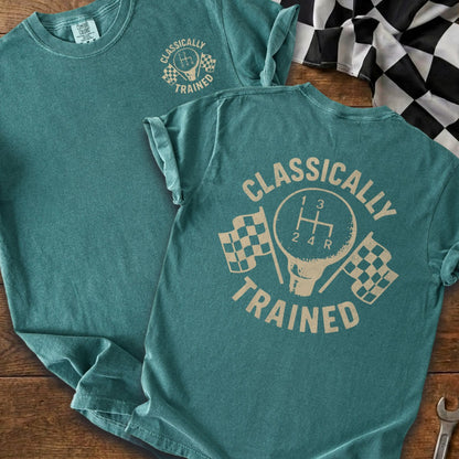 Teal t-shirt with "CLASSICALLY TRAINED" text and gear shift graphic with checkered flags.
