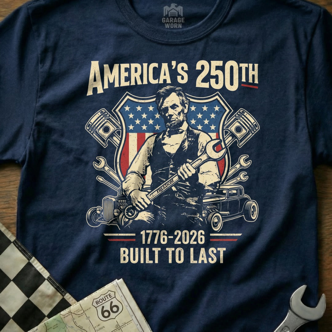 Abraham Lincoln graphic on a t-shirt with American flag, wrenches, and "America's 250th Built to Last".