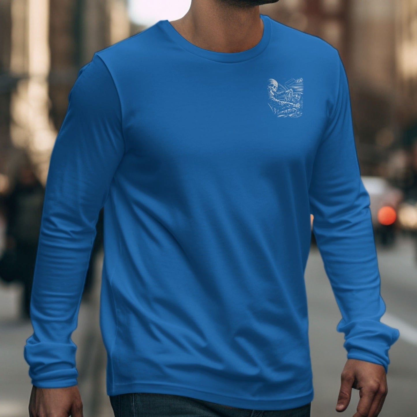 Blue long sleeve t-shirt with skeleton driving graphic on left chest.