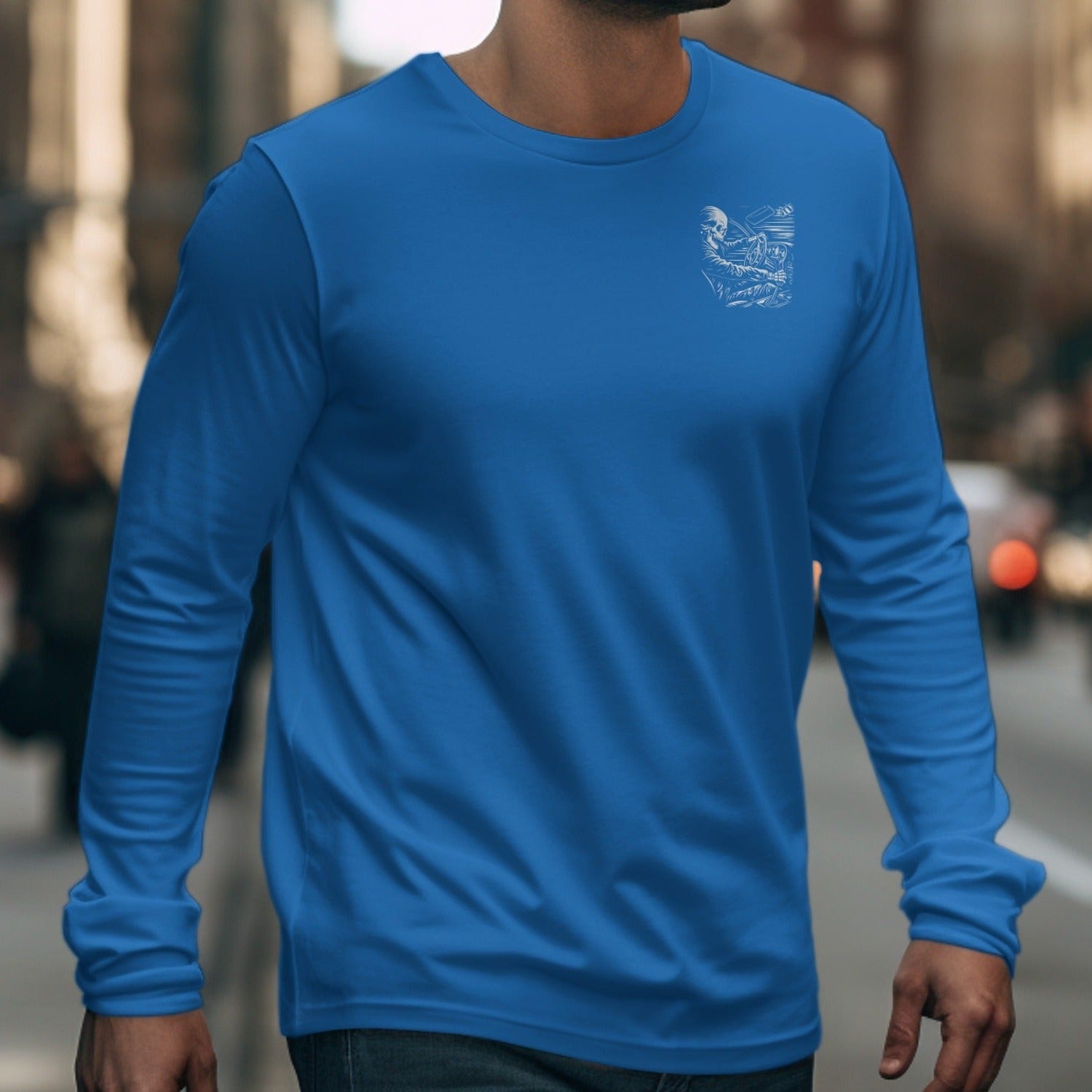 Blue long sleeve t-shirt with skeleton driving graphic on left chest.