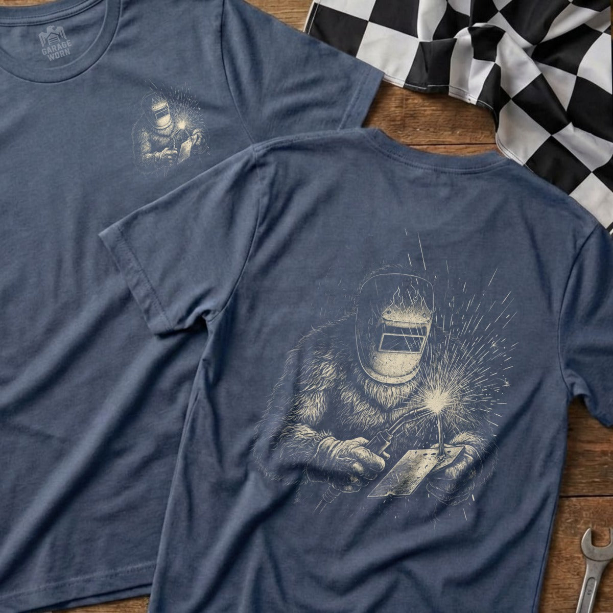 Blue t-shirt with a welder illustration and "Garage Worn" logo.