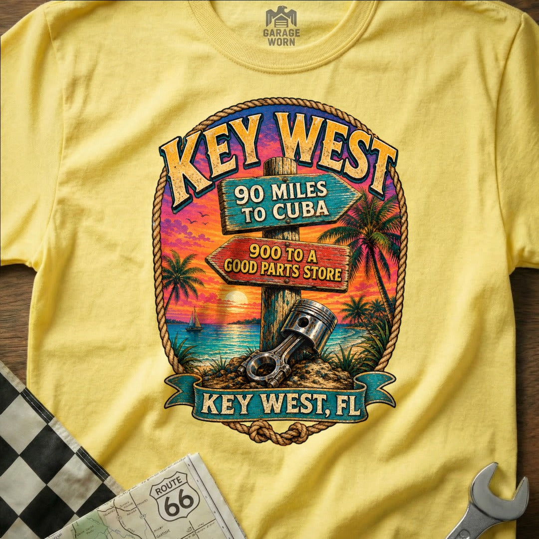 Key West, FL shirt with sunset, palm trees, and automotive piston graphic.