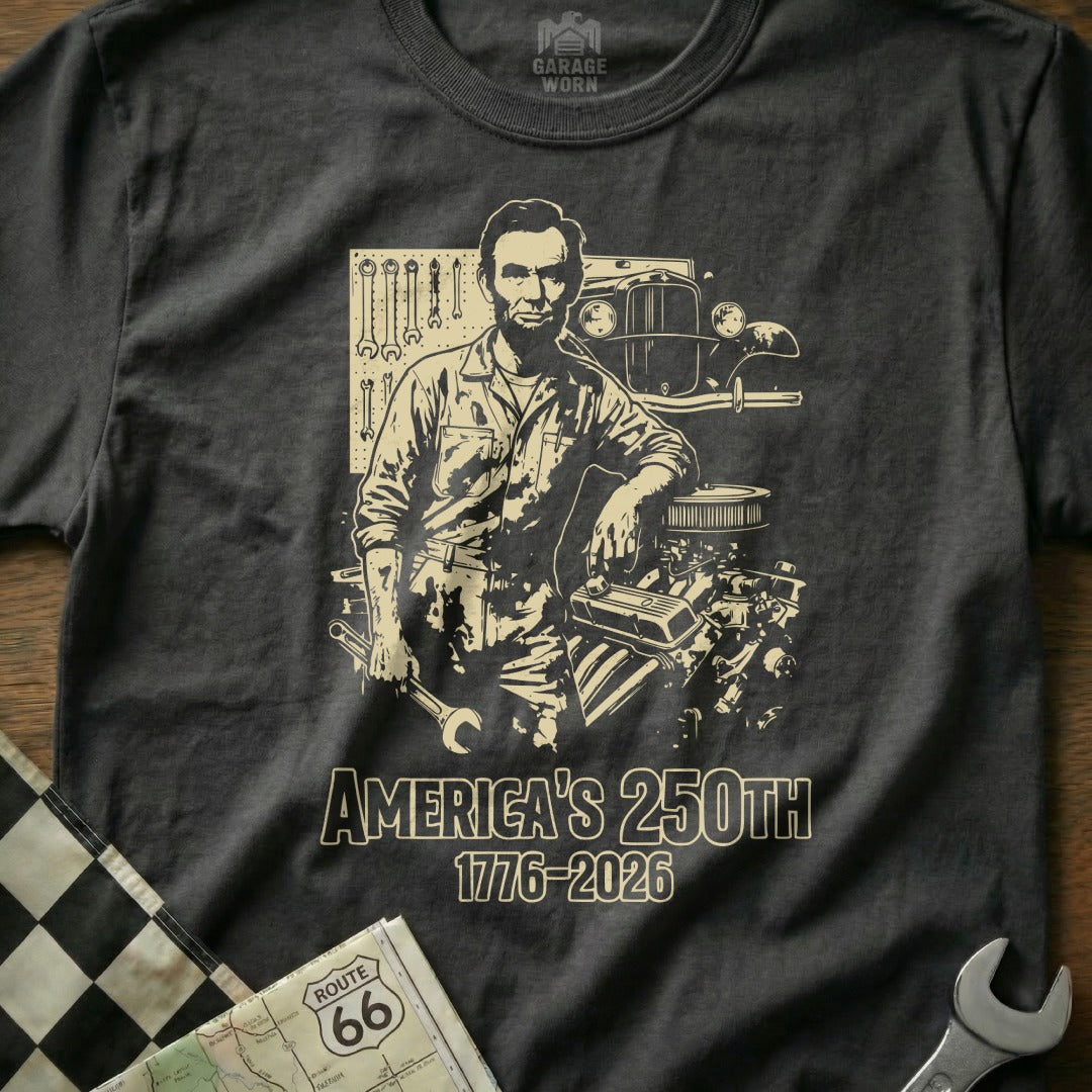 Abraham Lincoln leans on car engine with tools, text "America's 250th 1776-2026".