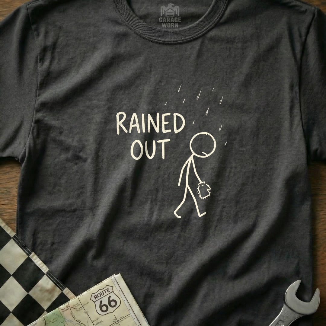 Dark gray t-shirt with a stick figure walking in the rain and "RAINING OUT" text.