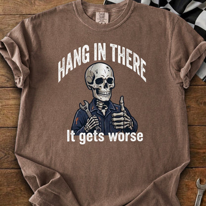 Brown t-shirt with skeleton mechanic graphic and text "Hang In There. It gets worse."