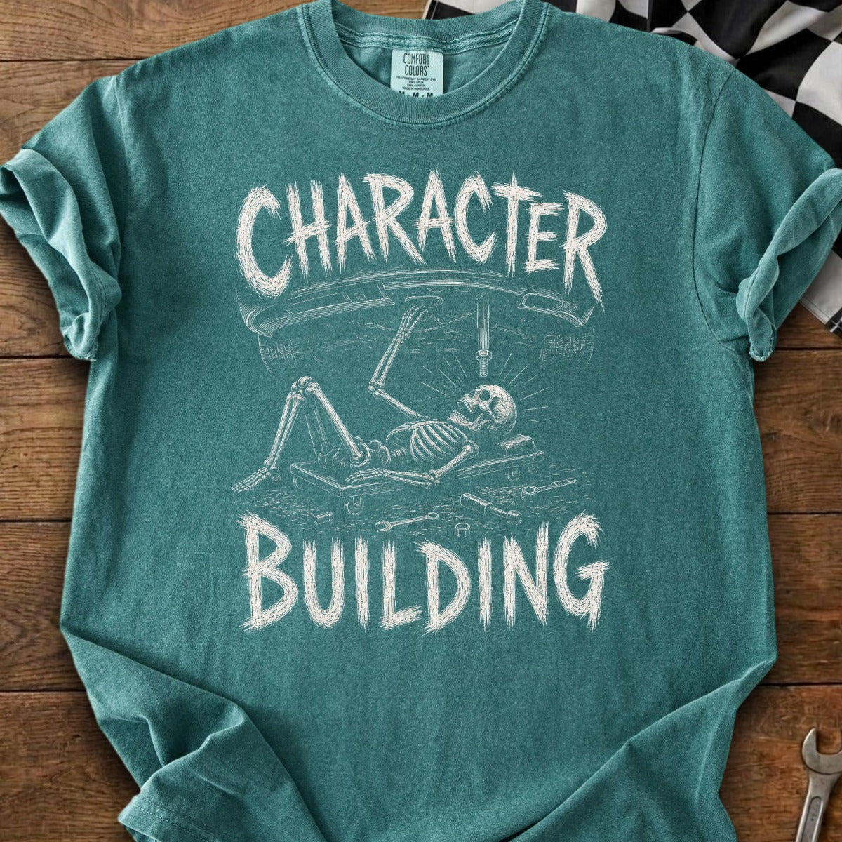 Skeleton working on a car under the words "CHARACTER BUILDING".