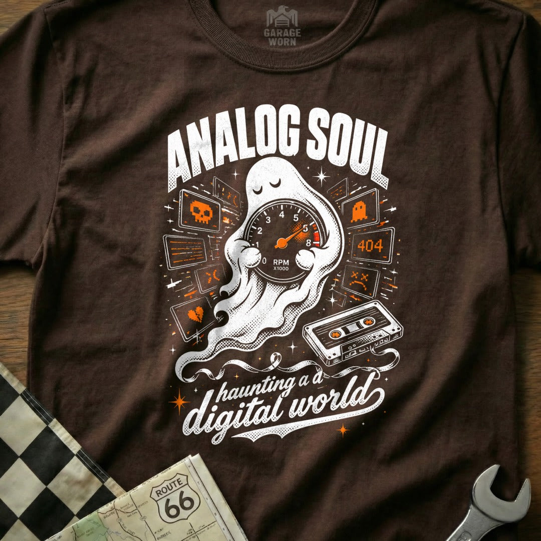 Brown t-shirt with a ghost holding a speedometer and text "Analog Soul Haunting a Digital World".