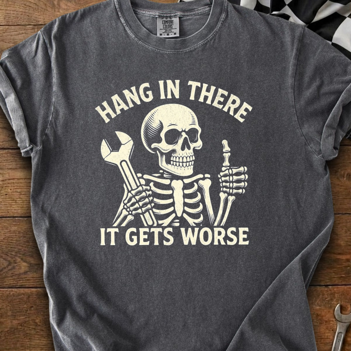 Gray t-shirt with skeleton holding wrench and giving thumbs up, text "Hang In There It Gets Worse".