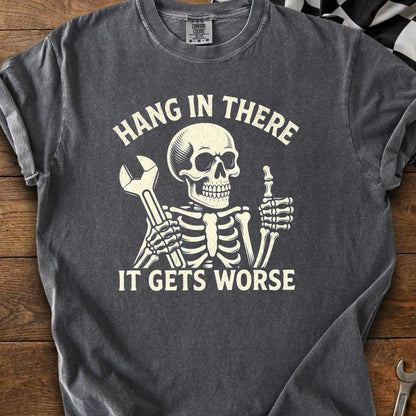 Gray t-shirt with skeleton holding wrench and giving thumbs up, text "Hang In There It Gets Worse".