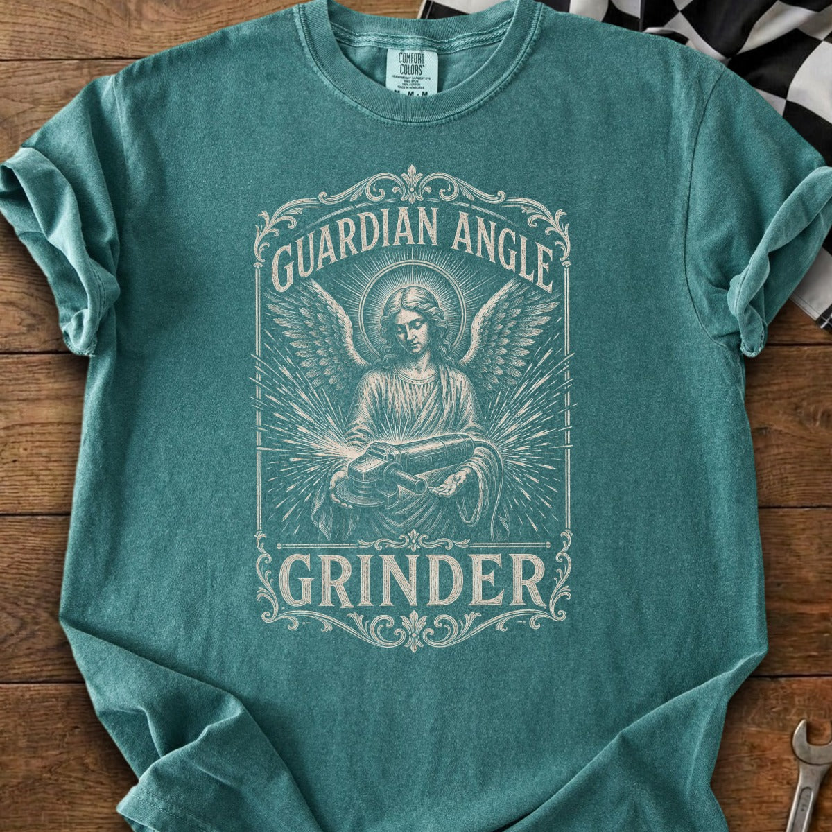 Guardian Angle Grinder graphic tee with angelic figure and tool.