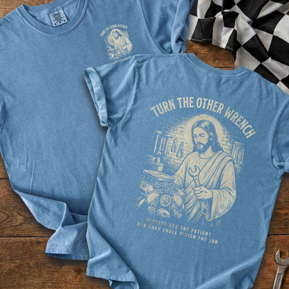 Blue t-shirt with Jesus holding a wrench and text "Turn the Other Wrench".
