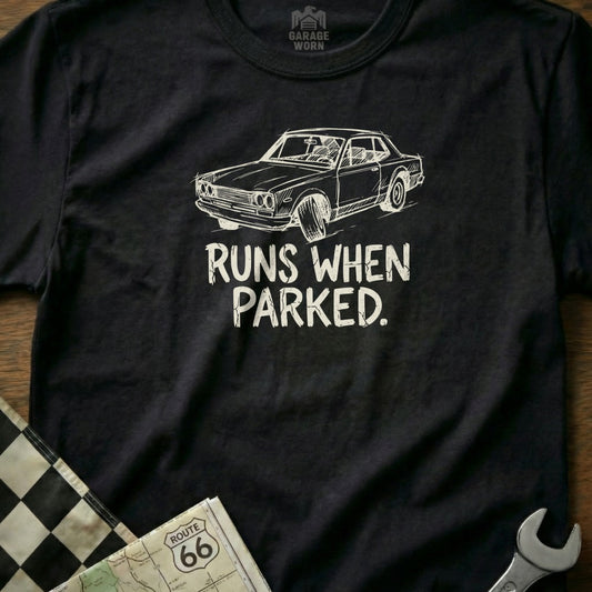 Black t-shirt with white sketch of a car and text "RUNS WHEN PARKED."