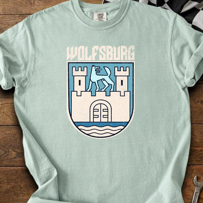 Light blue t-shirt with Wolfsburg crest featuring a wolf and castle.