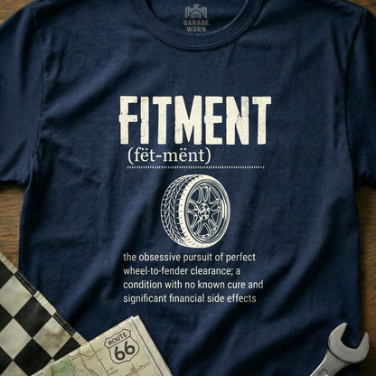 Navy t-shirt with "FITMENT" and wheel graphic, defining the term.