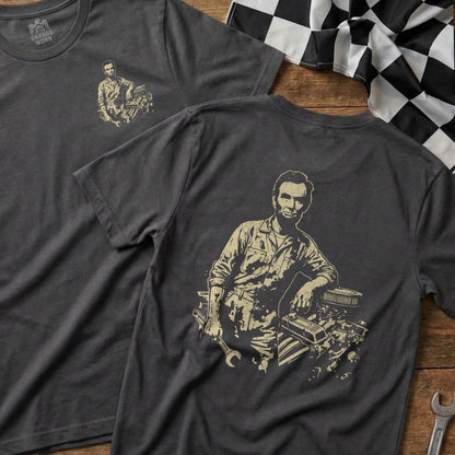 Abraham Lincoln graphic on a charcoal t-shirt, with tools and engine parts.